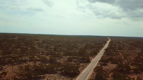 Australian desert with dirt path at sunset, Western Australia. Aerial backward t Video stock 294618916