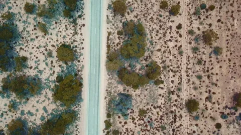 Australian desert with dirt path at sunset, Western Australia. Aerial backward t Stock Footage 294619024