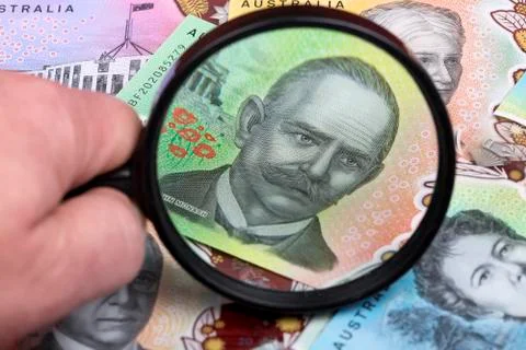 Australian dollars in a magnifying glass Stock Photos