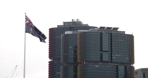 Australian flag blows in slow motion in front of Barangaroo towers Sydney Stock Footage 94025635