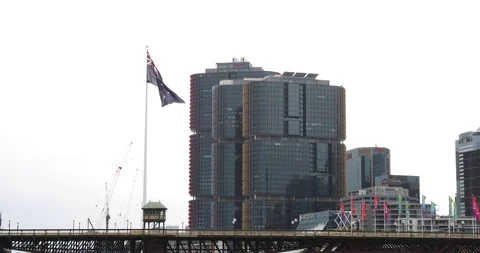 Australian flag blows in slow motion in barangaroo sydney Stock Footage 94025944