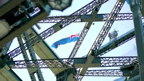 Australian flag flaps in the wind on Sydney's harbour bridge. Stock Footage 157155779