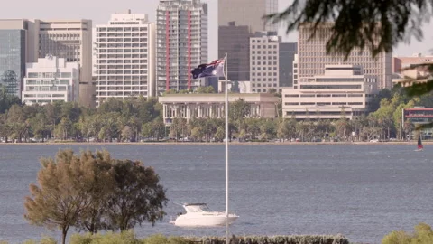 Australian flag flies high. Perth city skyscrapers visible in the background.  Stock Footage 146770081