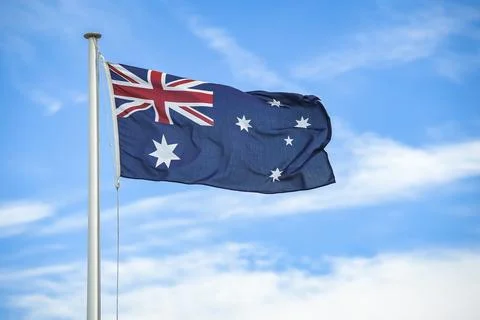 Australian flag flying on a flagpole. Stock Photos