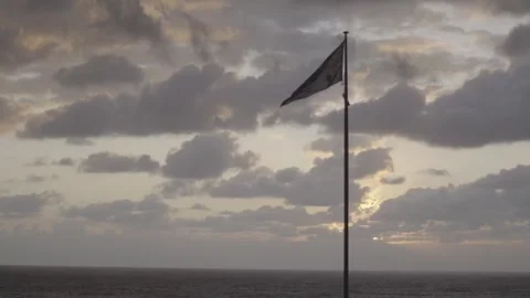 Australian flag flying over ocean sunset Stock-Footage 255176154