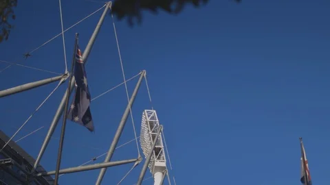Australian Flag waves with MCG light in the background Stock Footage 106599976