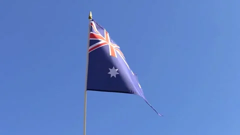 The Australian flag waving in the wind in the blue sky Stock Footage 282432729