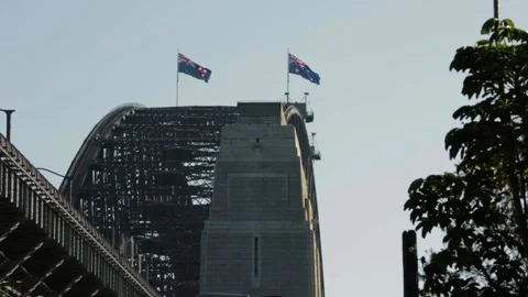 Australian Flags Flying on Sydney Harbour Bridge Steel Structure in Daylight Stock Footage 345719722