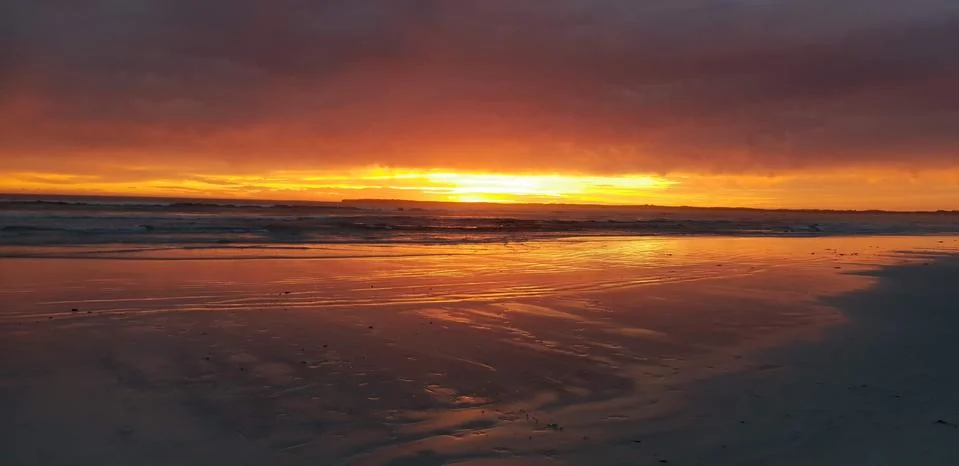 Australian sandy beach sunset Stock Photos