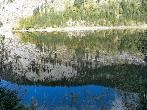 Austria. Gosausee. Mirror reflection of the Alpine mountain in the lake. Stock Photos