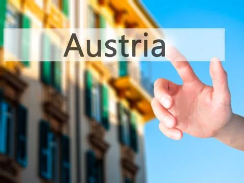Austria - Hand pressing a button on blurred background concept on visual scre Stock Photos