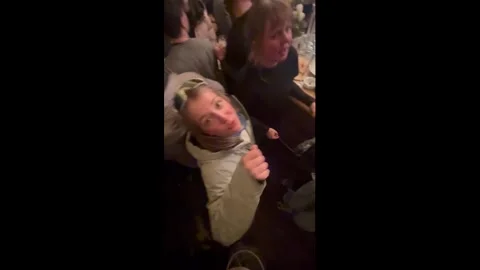 Austria: Man falls from table during barroom singalong in Tirol, Austria Video stock 330123312