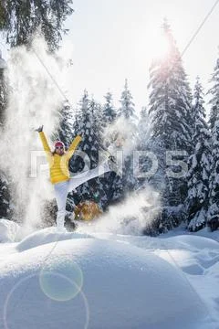 Austria, Salzburg State, Altenmarkt-Zauchensee, Woman With Snowshoes Jumping In