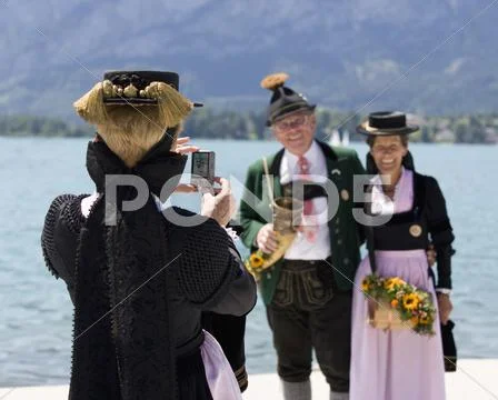 Austria, Salzburg, Woman taking photography of senior couple Stock Photos