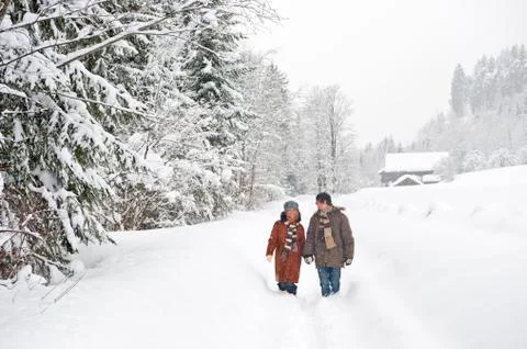 Austria, Salzburger Land, Altenmarkt, Cozple walking in snow covered landscape Stock Photos