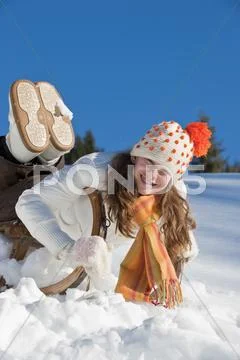 Austria, Salzburger Land, Altenmarkt, Girl (10-11) on sled, smiling, portrait Stock Photos