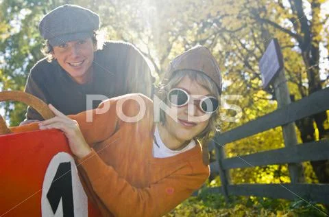 Austria, Salzburger Land, Man and boy (12-13) with soapbox car, smiling Stock Photos