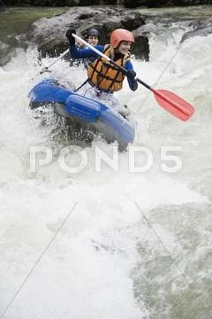 Austria, Salzburger Land, Young couple rowing kayak in lammer river Stock Photos