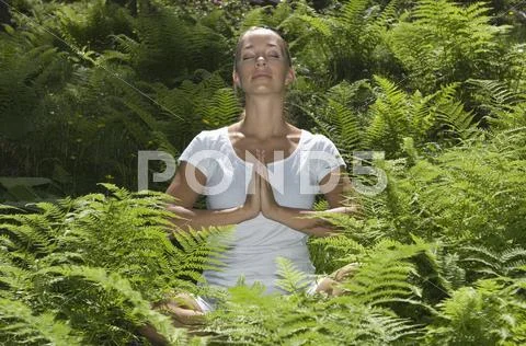 Austria, Salzburger Land, Young woman practising yoga Stock Photos