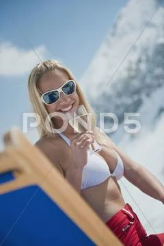 Austria, Salzburger Land, Young woman holding champagne glass, smiling, portrait Stock Photos