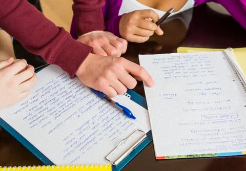 Austria, schoolwork, notebooks and hands Stock Photos