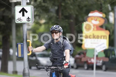 Austria, Styria, Graz, Mature man standing by road sign Stock Photos
