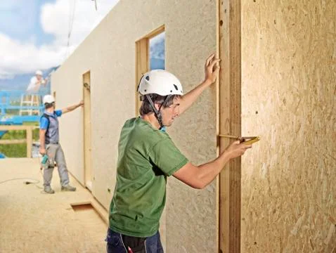 Austria, worker checking flakeboard with pocket rule Stock Photos