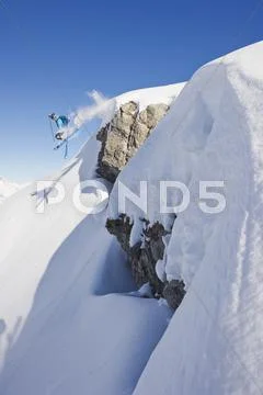 Austria, Zuers, Young Man Doing Telemark Skiing On Arlberg Mountain