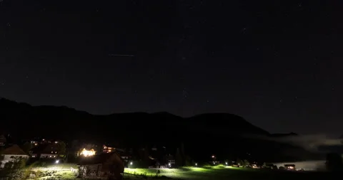 Austrian alps at night. 4k time lapse of the stars, sky and a rural valley. Stock Footage 252663975