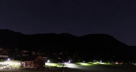 Austrian alps at night in 4k. Time lapse of start and cars passing in the dark. Stock Footage 252664187