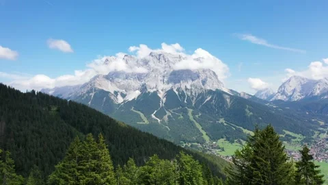 Austrian Alps Zugspitze mountain clouds horses Stock Footage 169856925