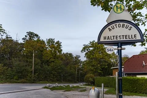 Austrian Bus Stop Sign on Suburban Street with Trees and Houses Stock Photos