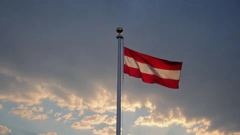 The Austrian Flag is majestically waving in the beautiful sunset, creating a Stock Footage 306178747
