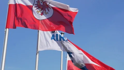 Austrian flag, Tyrolean flag and flag of Innsbruck airport in the wind. Stock Footage 107131940