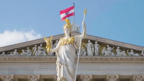 Austrian flag waving in the wind at Wien Parliament building, statue in front. Stock Footage 257807414