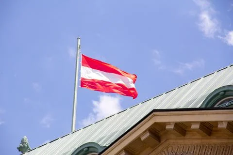 Austrian flag in wind on rooftop Stock Photos