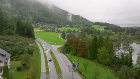 Austrian Lake Landscape Featuring a Scenic Mountain Road and Green Forest Stock-Footage 330953080