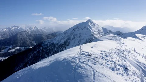 Austrian mountain top with cross covered in snow. Stock Footage 102658056