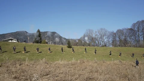 Austrian shooting team fires black powder guns in sequence on hillside Stock Footage 120988551