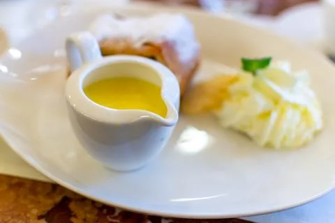 Austrian sweet dessert, portion of apple strudel with whippen cream and hot v Stock Photos