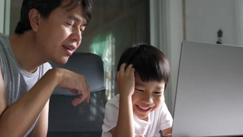 Authentic asian child boy using laptop with father.Kid talking to dad Video stock 218413105