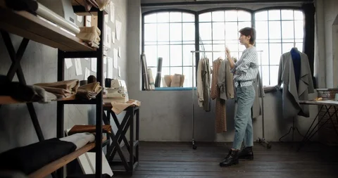 Authentic asian clothes designer is working at her office, looking at sketches Stock-Footage 128081822