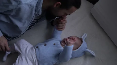 Authentic Bearded Long-haired Young Neo Father And Newborn Baby Looking Each Video stock 167952106