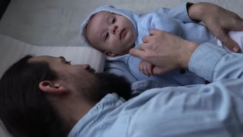Authentic Bearded Long-haired Young Neo Father And Newborn Baby Looking Each Stock Footage 167978597