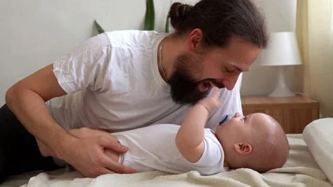 Authentic Bearded Long-haired Young Neo Father And Newborn Baby Looking Each Stock Footage 198527924