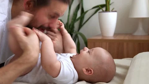 Authentic Bearded Long-haired Young Neo Father And Newborn Baby Looking Each Stock Footage 198934063