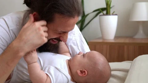 Authentic Bearded Long-haired Young Neo Father And Newborn Baby Looking Each Stock Footage 198934389