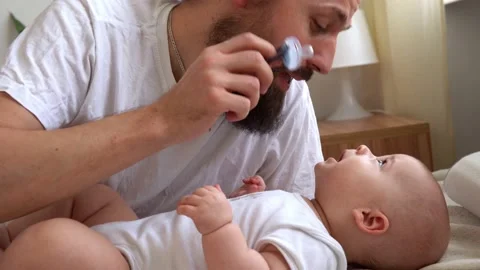 Authentic Bearded Long-haired Young Neo Father And Newborn Baby Looking Each Stock Footage 199666498