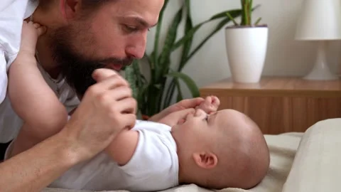 Authentic Bearded Long-haired Young Neo Father And Newborn Baby Looking Each Video stock 200907020