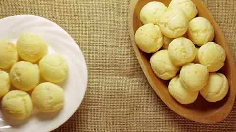 Authentic Brazilian cheese bread served on screen, first in a rustic wooden.. Видео 337274642